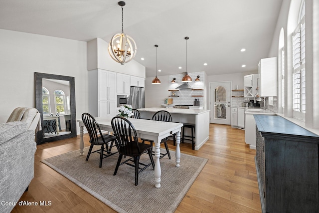 3515 N 7th St, Coeur Dalene, ID 83815 - dining area with a chandelier, high vaulted ceiling, light wood-type flooring, and recessed lighting