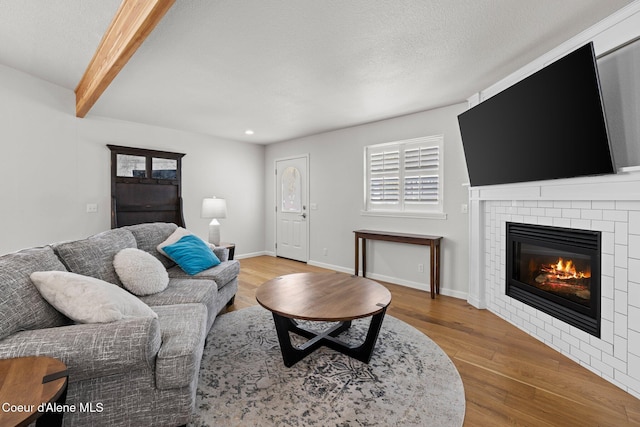 3515 N 7th St, Coeur Dalene, ID 83815 - living area with a fireplace, wood finished floors, recessed lighting, beam ceiling, and baseboards