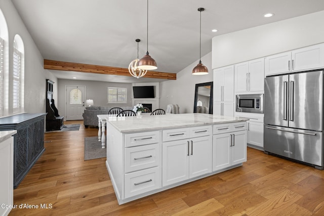 3515 N 7th St, Coeur Dalene, ID 83815 - kitchen with stainless steel appliances, a fireplace, recessed lighting, beam ceiling, and light wood-type flooring