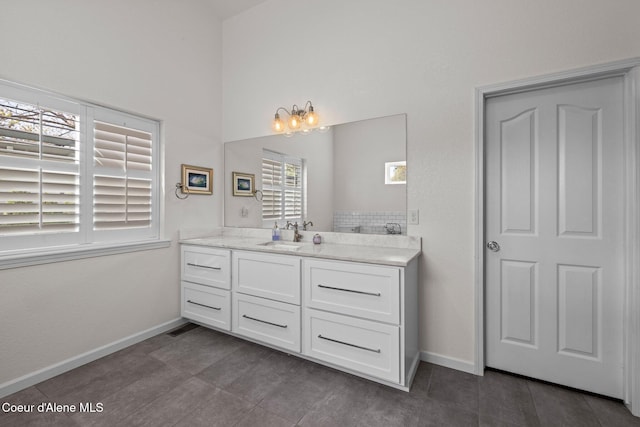 3515 N 7th St, Coeur Dalene, ID 83815 - bathroom featuring baseboards, vanity, and a towering ceiling