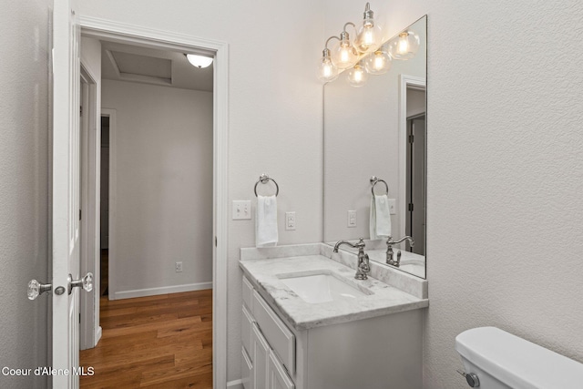 3515 N 7th St, Coeur Dalene, ID 83815 - half bathroom featuring wood finished floors, toilet, and vanity