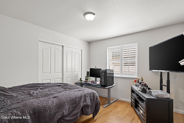 3515 N 7th St, Coeur Dalene, ID 83815 - bedroom with a closet, light wood-style flooring, baseboards, and a textured ceiling
