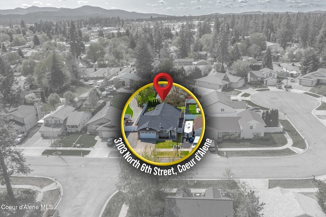 3515 N 7th St, Coeur Dalene, ID 83815 - aerial view of residential area with a mountainous background and a heavily wooded area