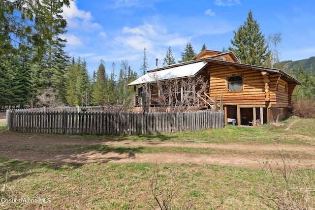 exterior space with fence and log siding
