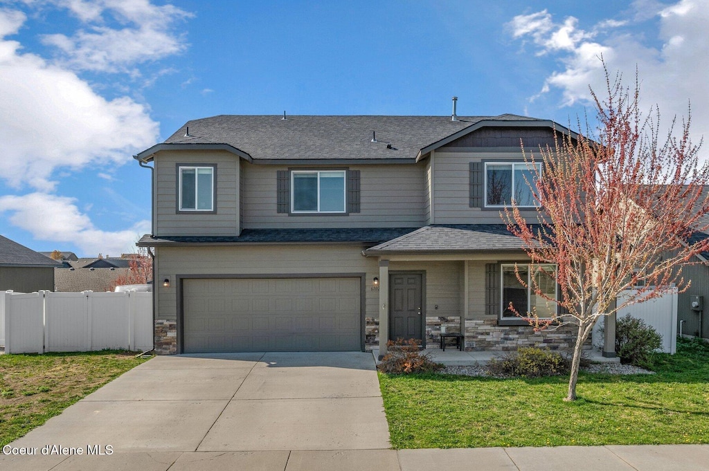 6102 W Lofty Ridge St, Rathdrum, ID 83858 - craftsman house featuring concrete driveway, roof with shingles, a front yard, fence, and a garage