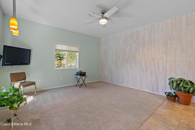 unfurnished room with a ceiling fan and baseboards