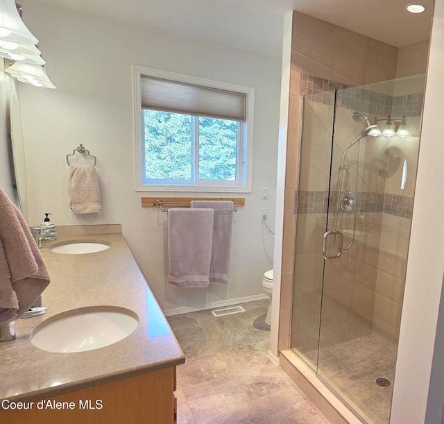 full bathroom featuring visible vents, a shower stall, and a sink