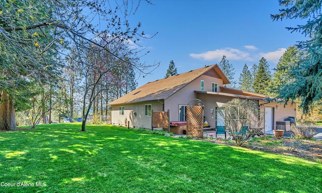 back of house with a lawn