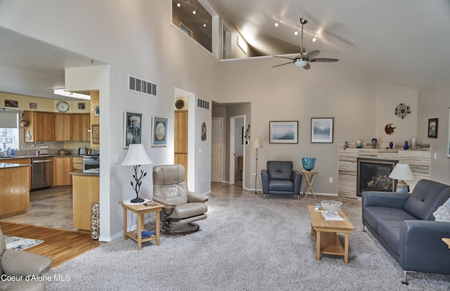 16691 W Hollister Hills Dr, Hauser, ID 83854 - carpeted living area with a ceiling fan, high vaulted ceiling, and a fireplace