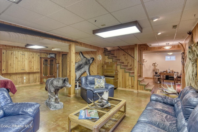 2885 S Folsom Ridge Rd, Coeur Dalene, ID 83814 - living area featuring wood walls, concrete floors, stairway, and a paneled ceiling