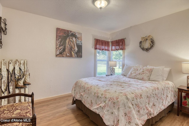 2885 S Folsom Ridge Rd, Coeur Dalene, ID 83814 - bedroom featuring light wood-type flooring and baseboards