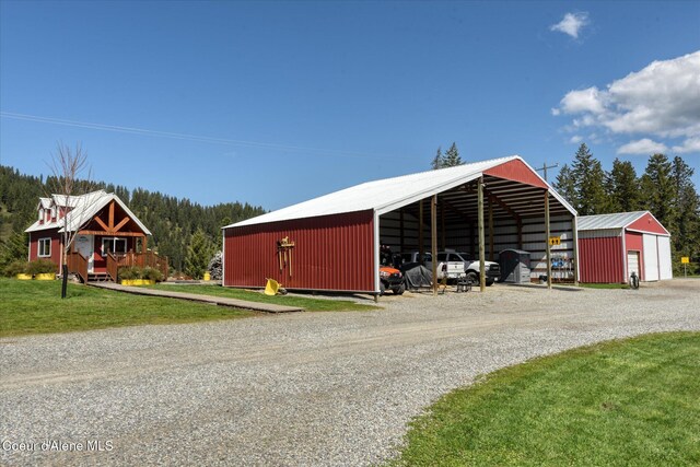 2885 S Folsom Ridge Rd, Coeur Dalene, ID 83814 - view of pole building featuring gravel driveway, a lawn, and a carport