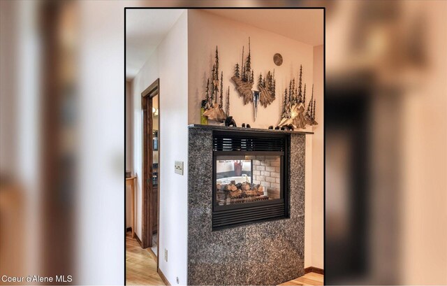 2885 S Folsom Ridge Rd, Coeur Dalene, ID 83814 - detailed view of a multi sided fireplace and wood finished floors