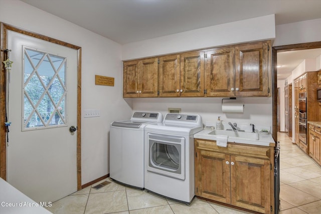 2885 S Folsom Ridge Rd, Coeur Dalene, ID 83814 - laundry area featuring separate washer and dryer, cabinet space, and light tile patterned floors