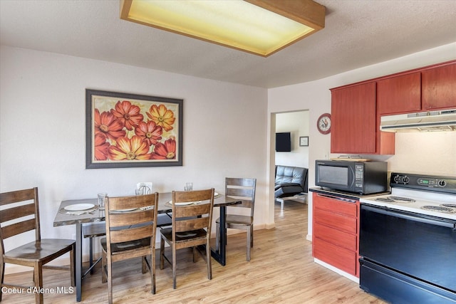 2885 S Folsom Ridge Rd, Coeur Dalene, ID 83814 - kitchen with range with electric stovetop, under cabinet range hood, black microwave, and light wood-type flooring
