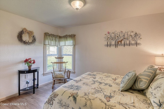 2885 S Folsom Ridge Rd, Coeur Dalene, ID 83814 - bedroom featuring wood finished floors, baseboards, and a textured ceiling