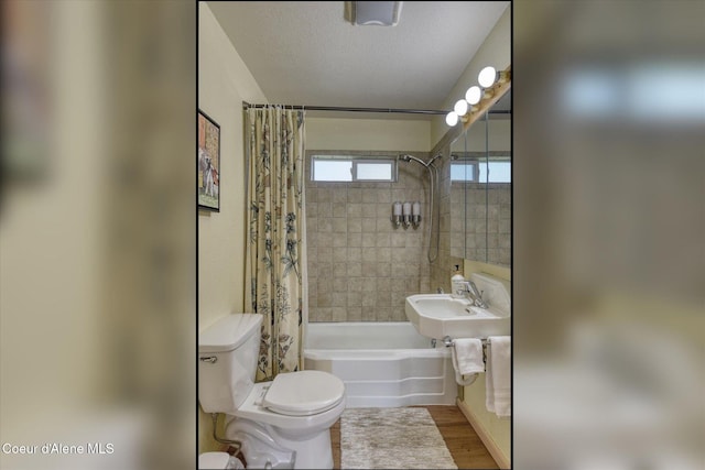 2885 S Folsom Ridge Rd, Coeur Dalene, ID 83814 - bathroom with shower / bathtub combination with curtain, toilet, wood finished floors, and a sink