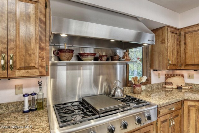 2885 S Folsom Ridge Rd, Coeur Dalene, ID 83814 - kitchen featuring brown cabinets, wall chimney exhaust hood, stainless steel gas cooktop, and light stone counters