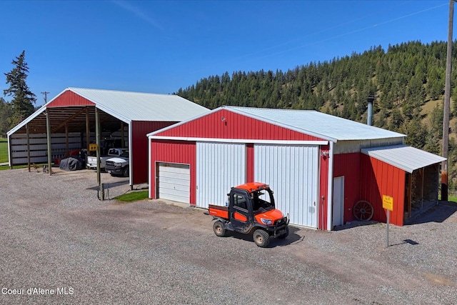 2885 S Folsom Ridge Rd, Coeur Dalene, ID 83814 - view of pole building with a forest view and dirt driveway