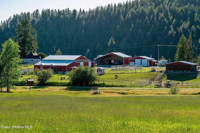 2885 S Folsom Ridge Rd, Coeur Dalene, ID 83814 - view of yard with an outbuilding, an outdoor structure, a forest view, and a view of countryside