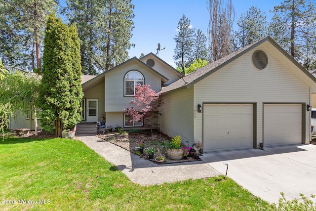 tri-level home with roof with shingles, an attached garage, driveway, and a front lawn