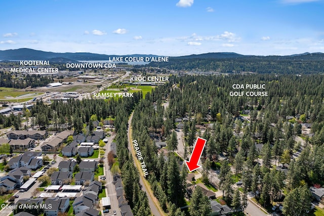 bird's eye view featuring a residential view, a view of trees, and a mountain view