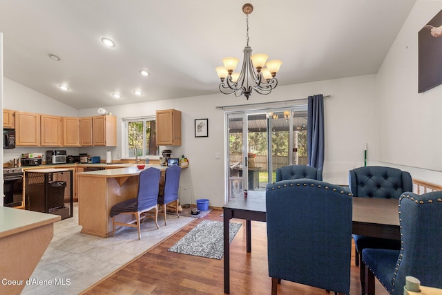 dining area featuring an inviting chandelier, recessed lighting, light wood-style floors, and vaulted ceiling