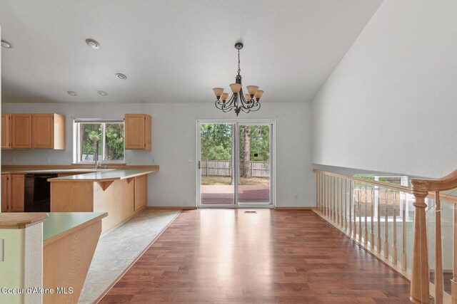 3868 N Palmer Dr, Coeur Dalene, ID 83815 - kitchen with black dishwasher, light brown cabinetry, healthy amount of natural light, and light wood-style floors
