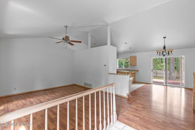 3868 N Palmer Dr, Coeur Dalene, ID 83815 - empty room with lofted ceiling, a chandelier, ceiling fan, and light wood-style flooring