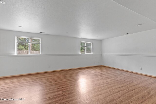 3868 N Palmer Dr, Coeur Dalene, ID 83815 - unfurnished room featuring wood finished floors and a textured ceiling