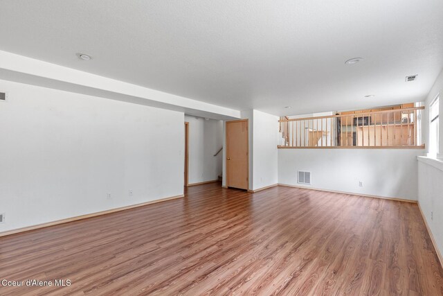 3868 N Palmer Dr, Coeur Dalene, ID 83815 - unfurnished living room featuring wood finished floors and baseboards