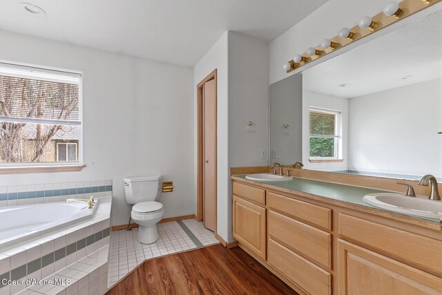 3868 N Palmer Dr, Coeur Dalene, ID 83815 - full bath featuring double vanity, a garden tub, and wood finished floors