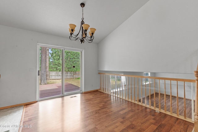 3868 N Palmer Dr, Coeur Dalene, ID 83815 - unfurnished room with vaulted ceiling, a chandelier, and wood finished floors