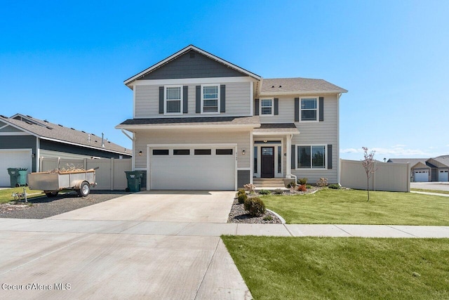 traditional home featuring fence, driveway, a front yard, and a garage