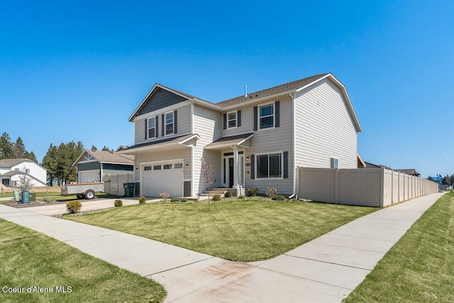 traditional-style house with a front yard, driveway, an attached garage, and fence