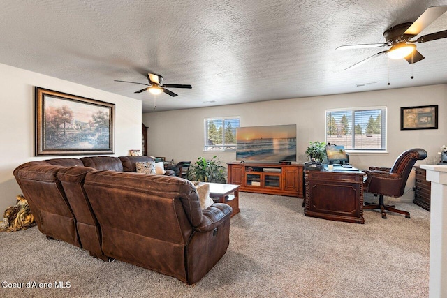 living room with ceiling fan, a wealth of natural light, and light carpet