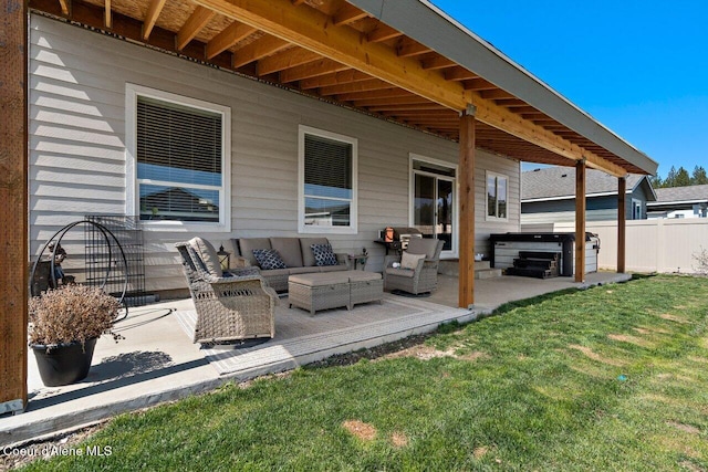 view of patio / terrace featuring an outdoor living space, fence, and a hot tub