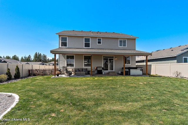 back of property featuring a patio, a yard, a fenced backyard, a hot tub, and an outdoor hangout area