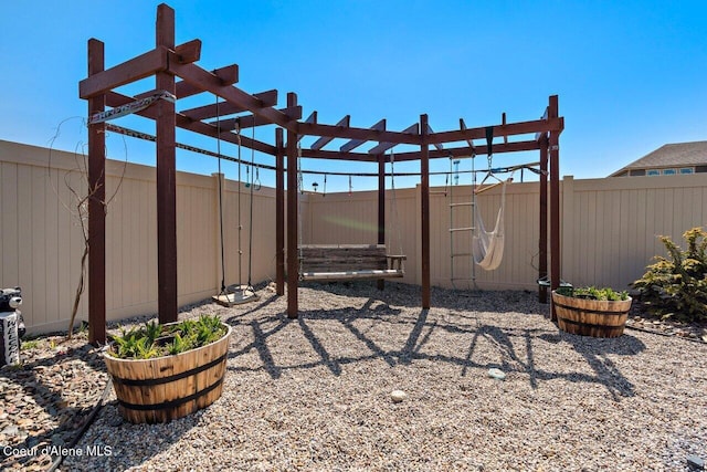 view of yard featuring a playground, a pergola, and a fenced backyard