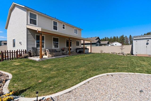 back of house featuring a lawn, a patio area, an outdoor living space, and a fenced backyard