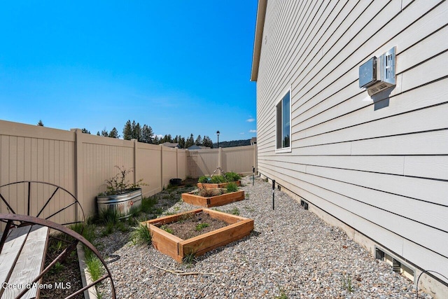 view of yard featuring a vegetable garden and a fenced backyard