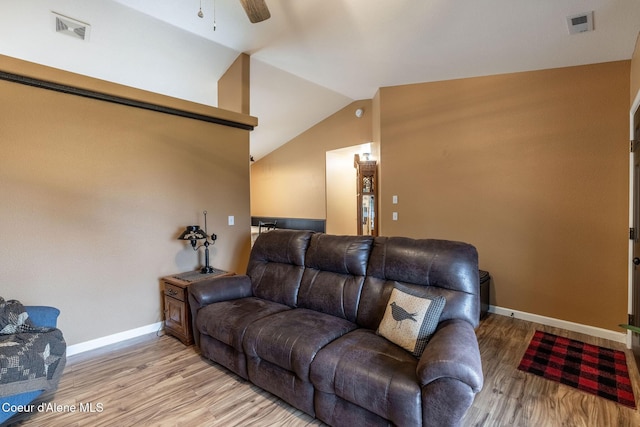 living room with light wood finished floors, visible vents, ceiling fan, and lofted ceiling