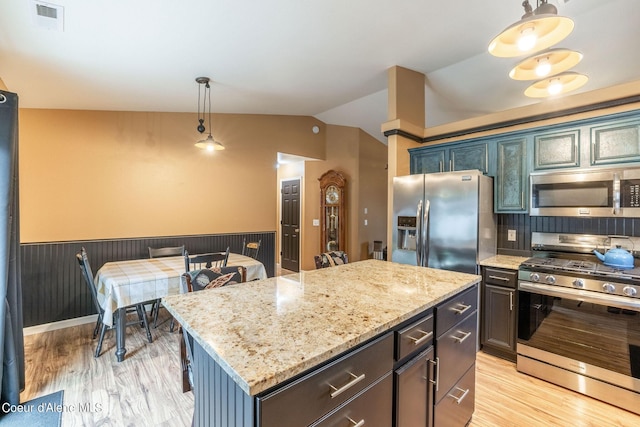 kitchen featuring visible vents, stainless steel appliances, light wood finished floors, and vaulted ceiling