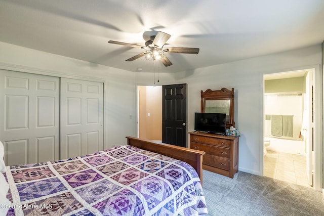 bedroom with a closet, ceiling fan, light carpet, and ensuite bathroom