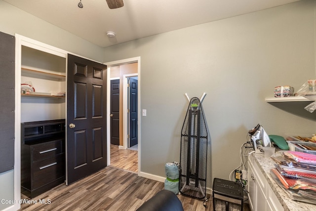 office featuring baseboards and dark wood-type flooring