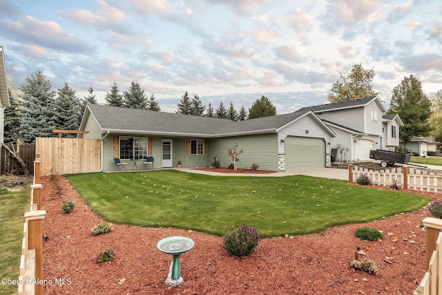 ranch-style house featuring a front lawn, a garage, concrete driveway, and fence