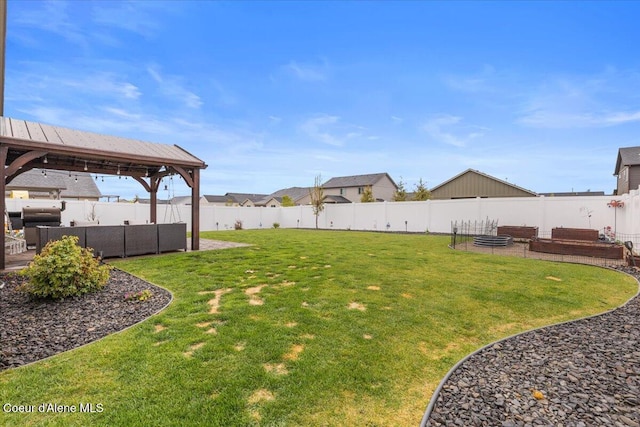 view of yard with an outdoor living space, a fenced backyard, and a gazebo