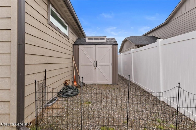 view of patio / terrace with a storage unit, fence, and an outbuilding
