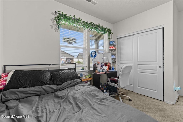 bedroom with a closet, carpet flooring, and visible vents