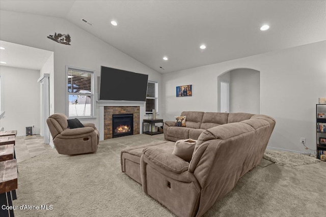 living room with recessed lighting, arched walkways, vaulted ceiling, and light carpet